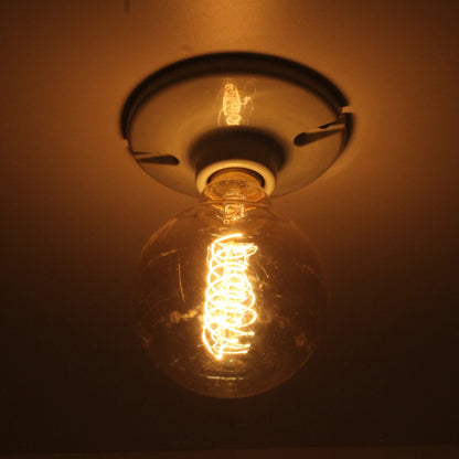 Lámpara vintage incandescente globo 35W con filamento espiral estilo Edison, luz cálida para ambiente.